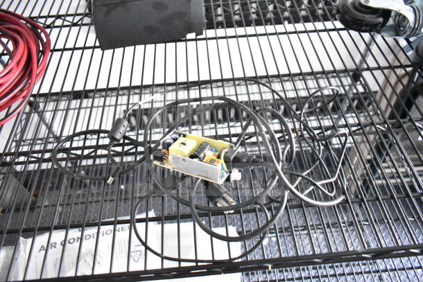 2020 Southern Dimensions beverage/food trailer interior, showcasing metal shelving with wiring and cables.