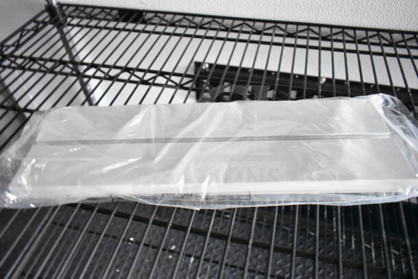 Plastic-wrapped metal panel on a wire shelf, part of 2020 Southern Dimensions 8.5x28 Beverage/Food Trailer equipment.
