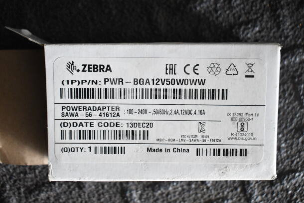 Zebra power adapter box; model PWR-BGA12V50W0W; 100-240V, 12VDC, 4.16A; made in China; barcode and certification logos visible.