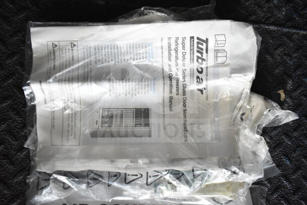 Manual for Turbo Air refrigerators and freezers, wrapped in plastic, showing installation and operation instructions.