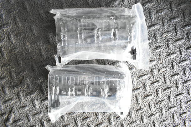 Clear plastic packaging containing unknown items on a textured surface.