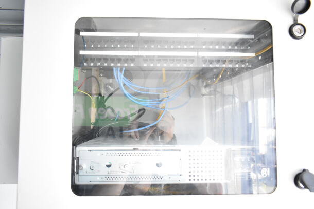 Internal view of 2020 Southern Dimensions 8.5x28 food trailer wiring and network setup, showing organized cables and ports.