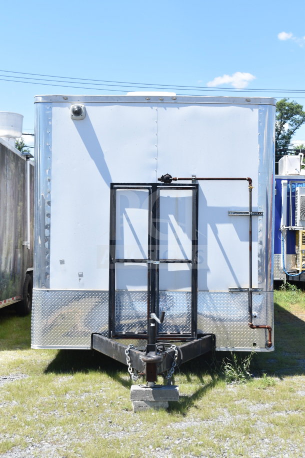 2021 Diamond Cargo 8.5x24 food trailer, white exterior, diamond plate accents, sturdy hitch, well-maintained condition.