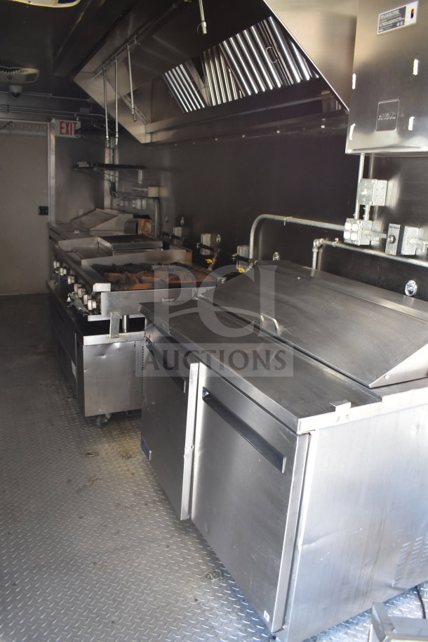 2021 Diamond Cargo 8.5x24 food trailer interior with stainless steel appliances, showing fryers, grills, and ventilation system.