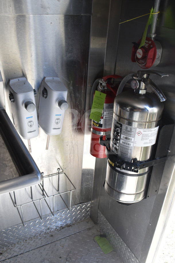 Interior of 2021 Diamond Cargo food trailer showing Ecolab soap dispensers, fire extinguisher, and fire suppression pull switch.