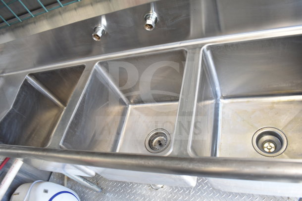 Stainless steel three-compartment sink inside a 2021 Diamond Cargo 8.5x24 food trailer; clean and well-maintained.