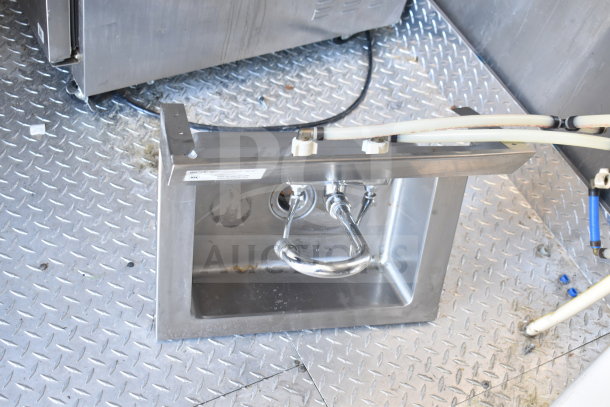 Stainless steel sink in a fully outfitted 2021 Diamond Cargo 8.5x24 food trailer. Features a durable metal floor.