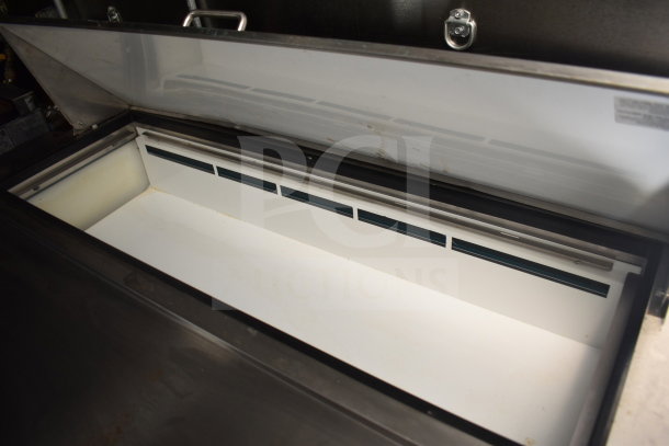 Open refrigeration unit inside a 2021 Diamond Cargo food trailer, featuring a grease hood and fire suppression system.