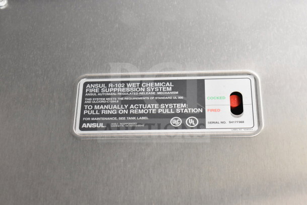 Ansul R-102 wet chemical fire suppression system label on a food trailer. Serial No. S4177368, showing operation status indicator.