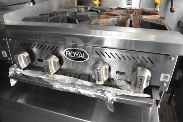 Royal branded range knobs on a stainless steel stove inside a 2021 Diamond Cargo 8.5x24 food trailer with grease hood.