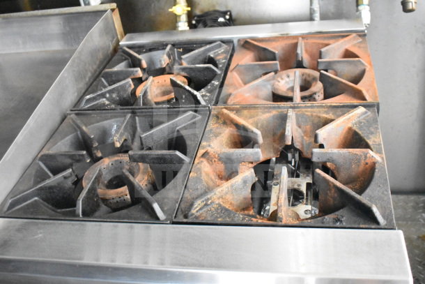 2021 Diamond Cargo food trailer interior with range and griddle, showing four-burner stove top. Features used condition.