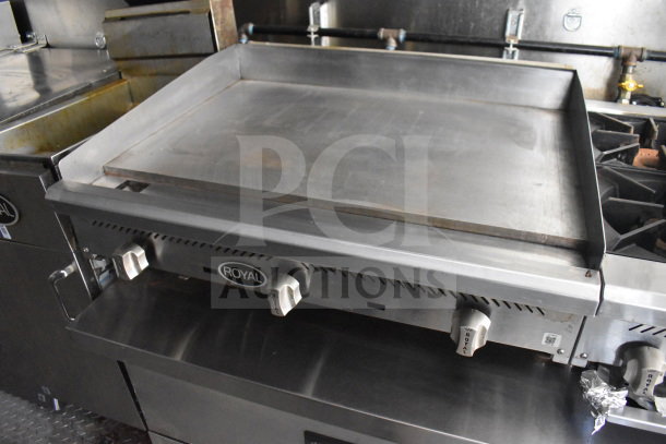Royal brand griddle in a Diamond Cargo food trailer with grease hood and fire suppression system, stainless steel surface.
