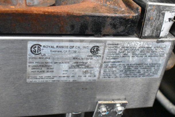 Sticker on Royal Range equipment detailing model RHP-24-4, BTUs, gas type, clearances, and usage warnings.