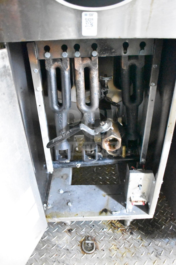 Inside view of 2021 Diamond Cargo 8.5x24 food trailer's cooking equipment, showing used burners and metal components.