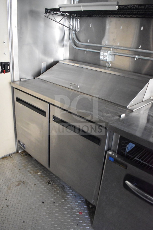 2021 Diamond Cargo 8.5x24 food trailer interior with stainless steel surfaces, grease hood, and refrigeration units.