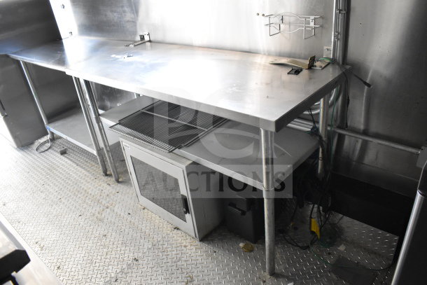 2021 Diamond Cargo 8.5x24 food trailer interior with stainless steel counters, grease hood, fire suppression system, range, and griddle.