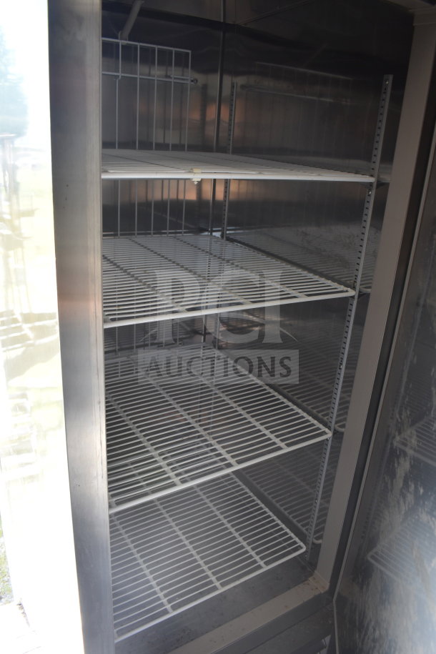 Diamond Cargo food trailer interior showing a large refrigeration unit with metal shelves. Clean and spacious.