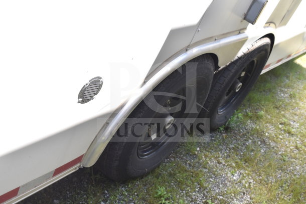 2021 Diamond Cargo food trailer with black dual wheels and aluminum fender trim, VIN 53NBE2421M1089857.