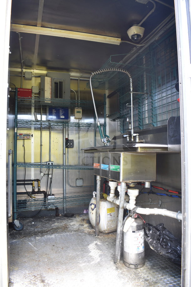 2020 Diamond Cargo 8.5x24 food trailer interior, featuring metal shelving, industrial sink, and electrical components.