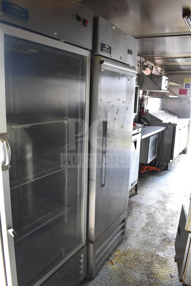 2020 Diamond Cargo 8.5x24 food trailer interior with Arctic Air refrigerators, stainless steel countertops, and storage.