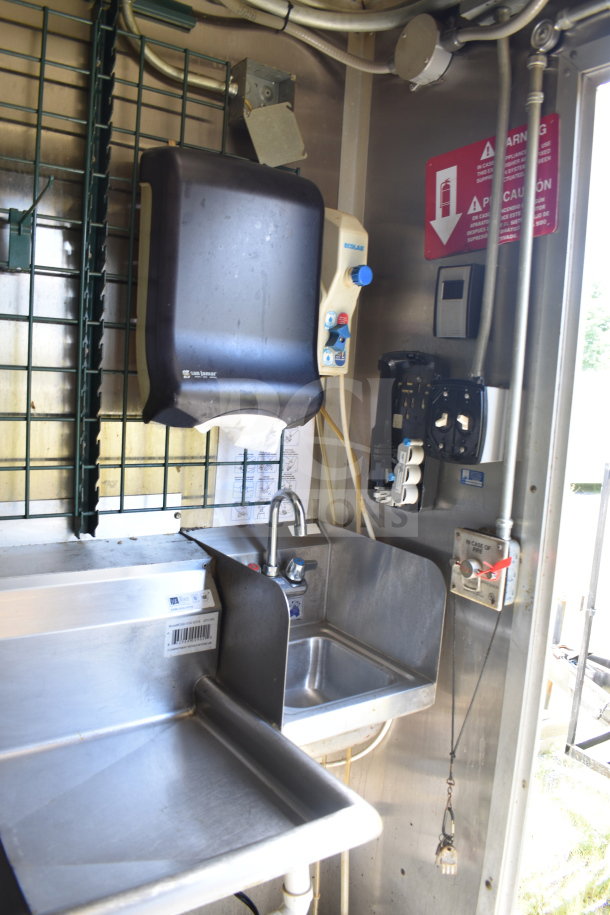 2020 Diamond Cargo 8.5x24 food trailer interior with stainless steel sink, paper towel dispenser, and safety warning sign.