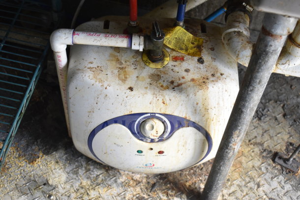 Dirty dual-knob water heater, visible dynamic pipes and stained metal grate, inside the 2020 Diamond Cargo food trailer.