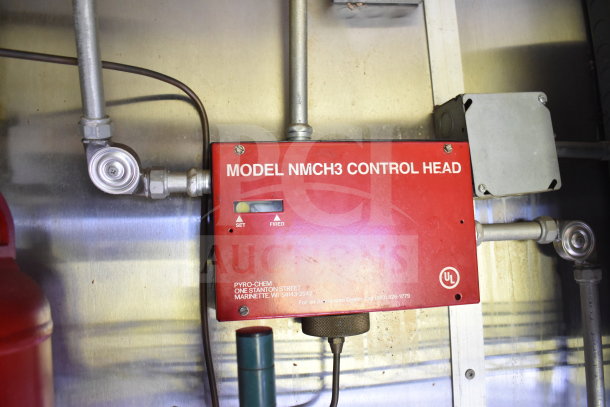 Red Model NMCH3 control head on 2020 Diamond Cargo food trailer interior wall. Visible wiring and setup.