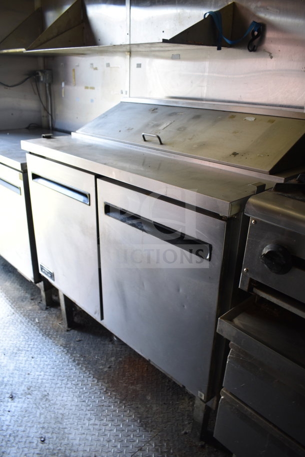 2020 Diamond Cargo 8.5x24 food trailer interior, featuring a stainless steel refrigerator, grease hood, and fryer.