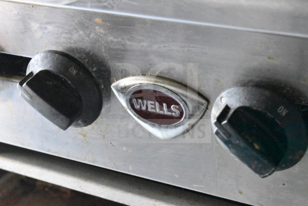 Close-up of Wells appliance control knobs on a used 2020 Diamond Cargo food trailer with grease hood and fryer.