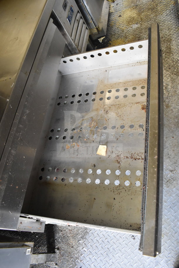 Open drawer inside 2020 Diamond Cargo 8.5x24 food trailer, showing signs of use with grease and debris.