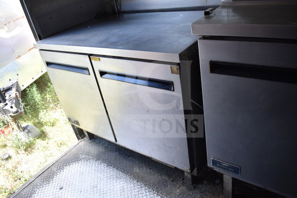 2020 Diamond Cargo 8.5x24 food trailer interior with dual stainless steel refrigerators; visible grease hood, fryer.