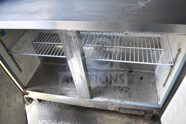 2020 Diamond Cargo food trailer's interior metal shelving, showing signs of use. Ideal for food equipment storage.