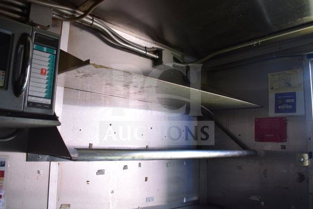 Interior of 2020 Diamond Cargo 8.5x24 food trailer showing shelving, wiring, microwave controls, and safety signage.