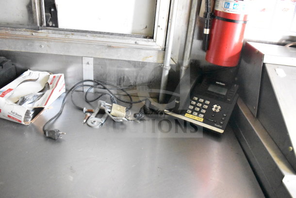 2020 Diamond Cargo 8.5x24 food trailer interior showing counter with Verizon phone, foil sheets, and assorted hardware.