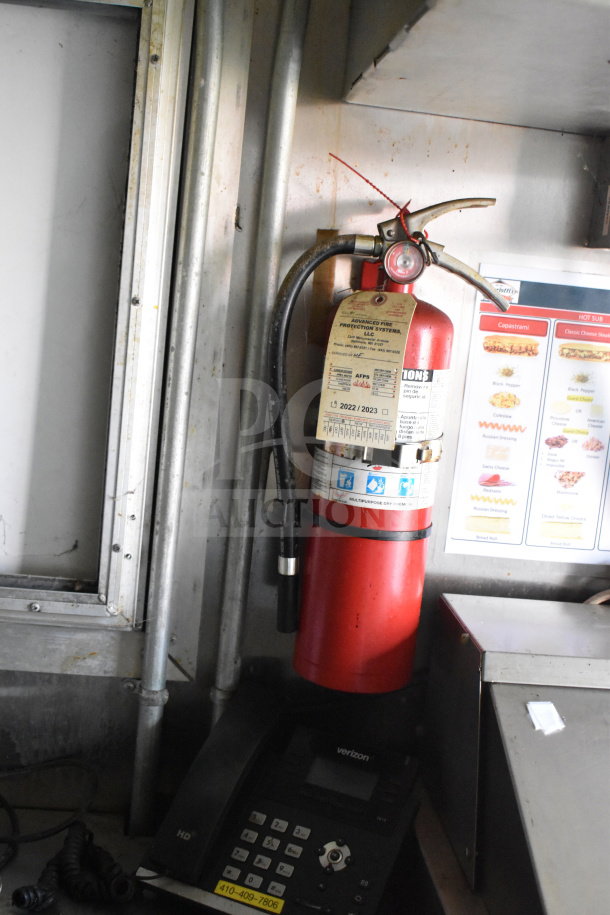 Interior of 2020 Diamond Cargo food trailer showing a fire extinguisher with inspection tags, menu, and phone.