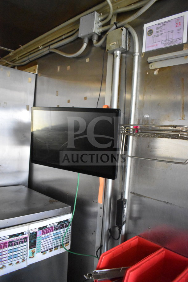 2020 Diamond Cargo 8.5x24 food trailer interior, showing stainless steel walls, mounted screen, and fryer control panel.