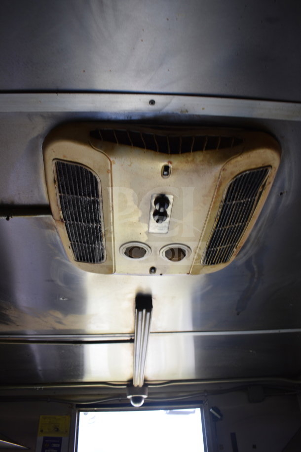 Interior view of a 2020 Diamond Cargo 8.5x24 food trailer's ceiling with ventilation system and lighting, showing signs of use.