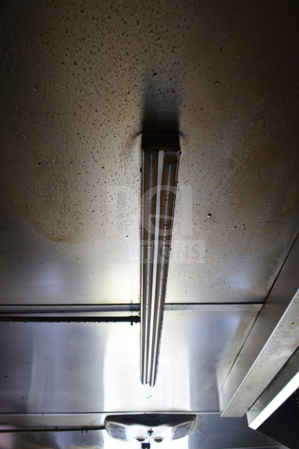 Ceiling of 2020 Diamond Cargo food trailer, featuring metal construction and fluorescent lighting, showing grease accumulation.