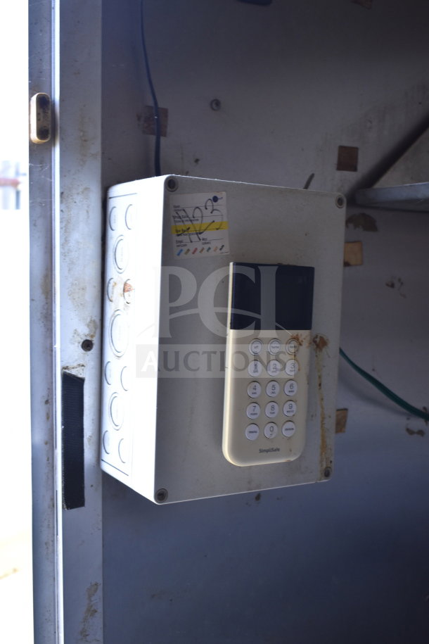 2020 Diamond Cargo 8.5x24 food trailer control panel with keypad. SimpliSafe label visible, shows wear.