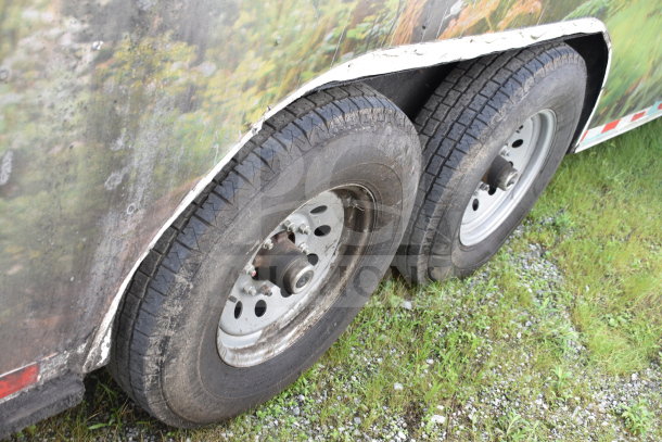 Dual wheels of a 2020 Diamond Cargo 8.5x24 food trailer, showing weathered tires and partial exterior surface.