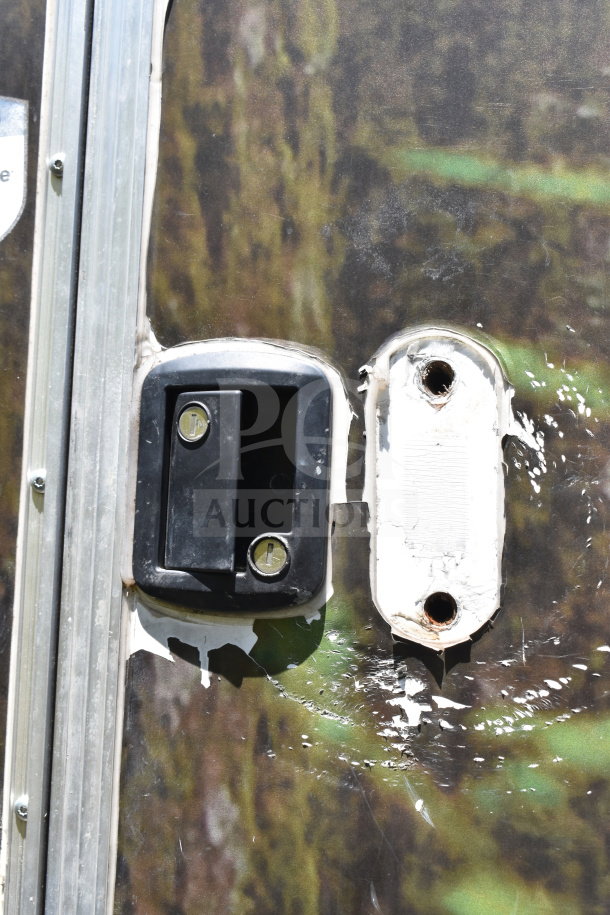 2020 Diamond Cargo 8.5x24 food trailer handle close-up, showing wear. Features grease hood, fryer, and refrigeration.