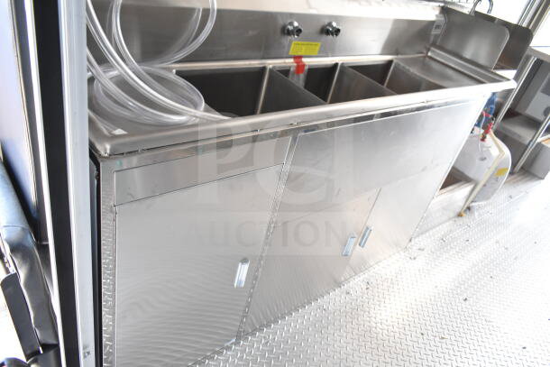 2020 Ford F59 Food Truck interior with stainless steel sink, under-counter storage, and visible hoses.
