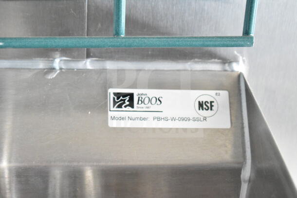 Tag on a metal surface displaying "John Boos, Model Number: PBHS-W-0909-SSLR," and "NSF" certification.