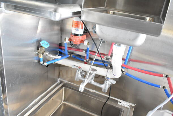 2020 Ford F59 food truck plumbing system with stainless steel sink, pipes, and fittings; includes visible grease hood installation.