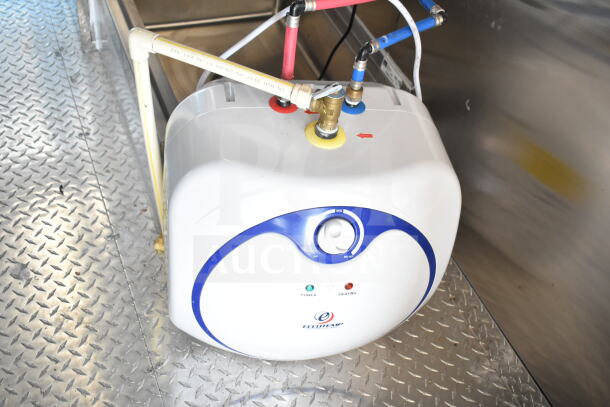 2020 Ford F59 Food Truck interior detail showing Ecotemp water heater unit with color-coded pipes on diamond plate floor.