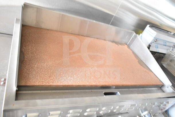 Interior of 2020 Ford F59 food truck showing cooking equipment including a grease hood, Pitco fryer, and chef base.