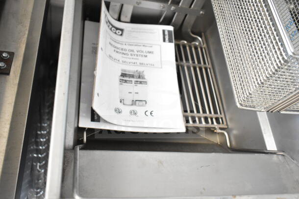Pitco fryer manual inside a 2020 Ford F59 food truck. Grease hood and suppression system partially visible.