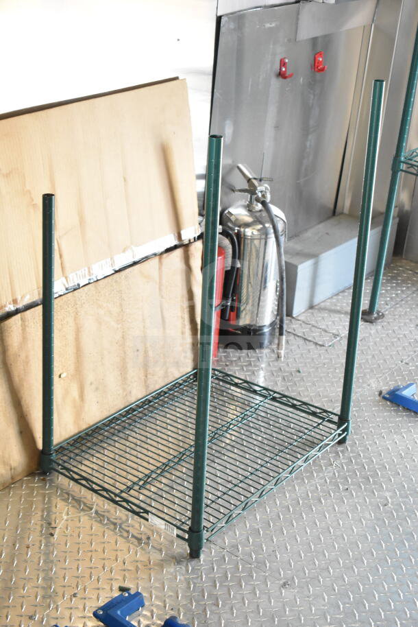 Metal shelving unit and fire extinguisher inside a 2020 Ford F59 food truck. Diamond plate flooring visible.