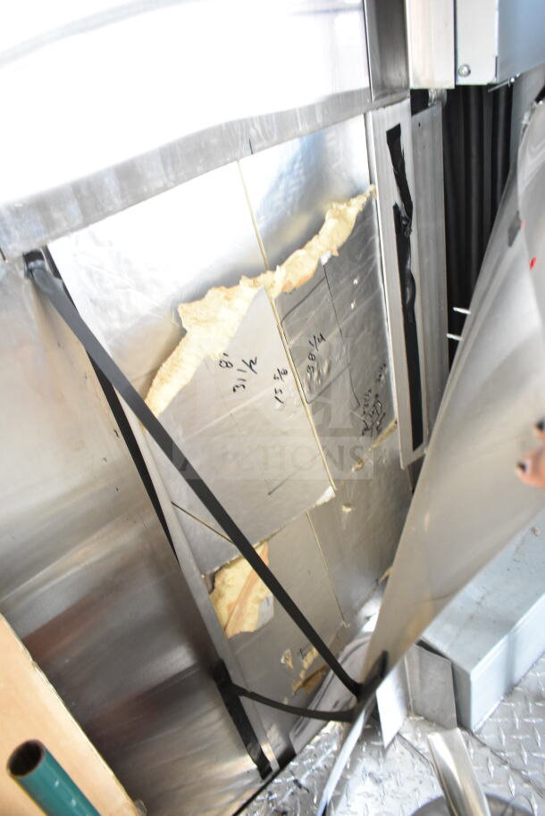 Damaged interior paneling of a 2020 Ford F59 Food Truck, showing broken insulation and exposed metal framework.