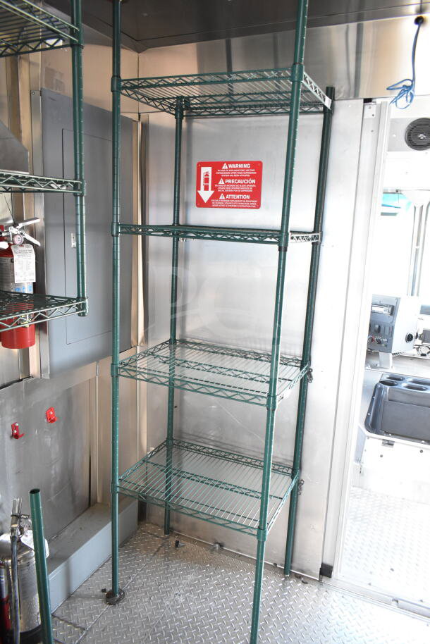 2020 Ford F59 food truck interior with metal shelves, grease hood, fire extinguisher, warning label, and suppression system.